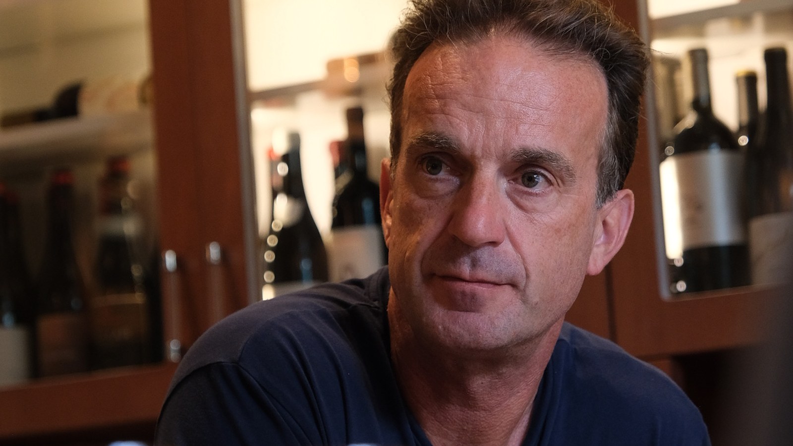 David Forer judging wines in a cellar setting